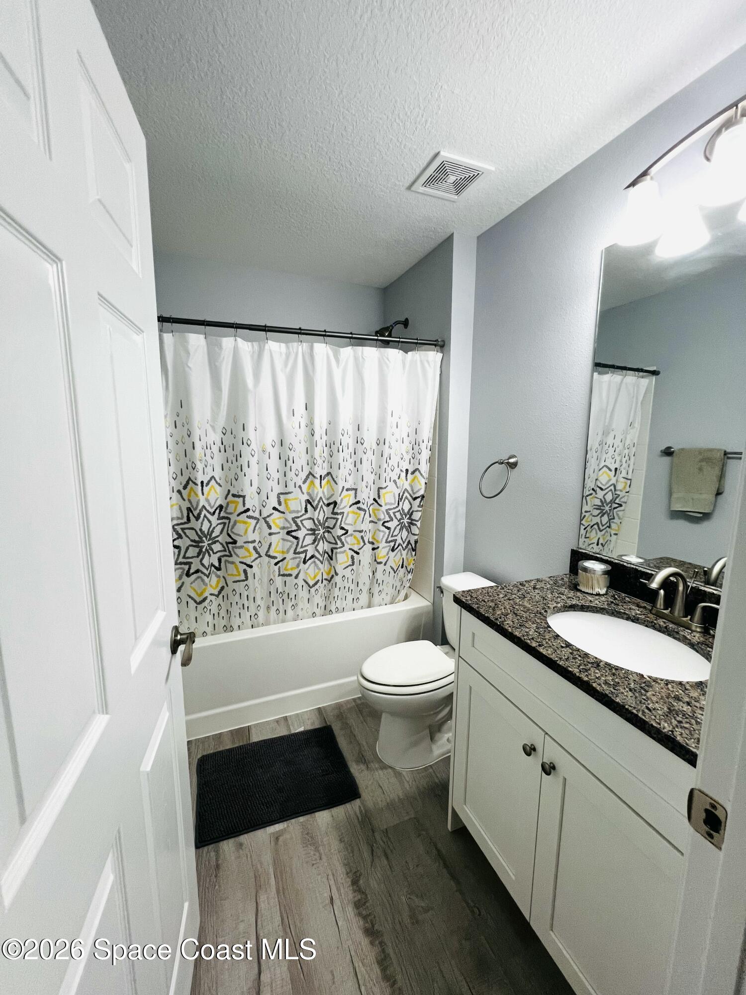 379 Wilton Avenue Southwest Melbourne, FL 32908 - Photo 19 of 26 a bathroom with a granite countertop sink and a mirror