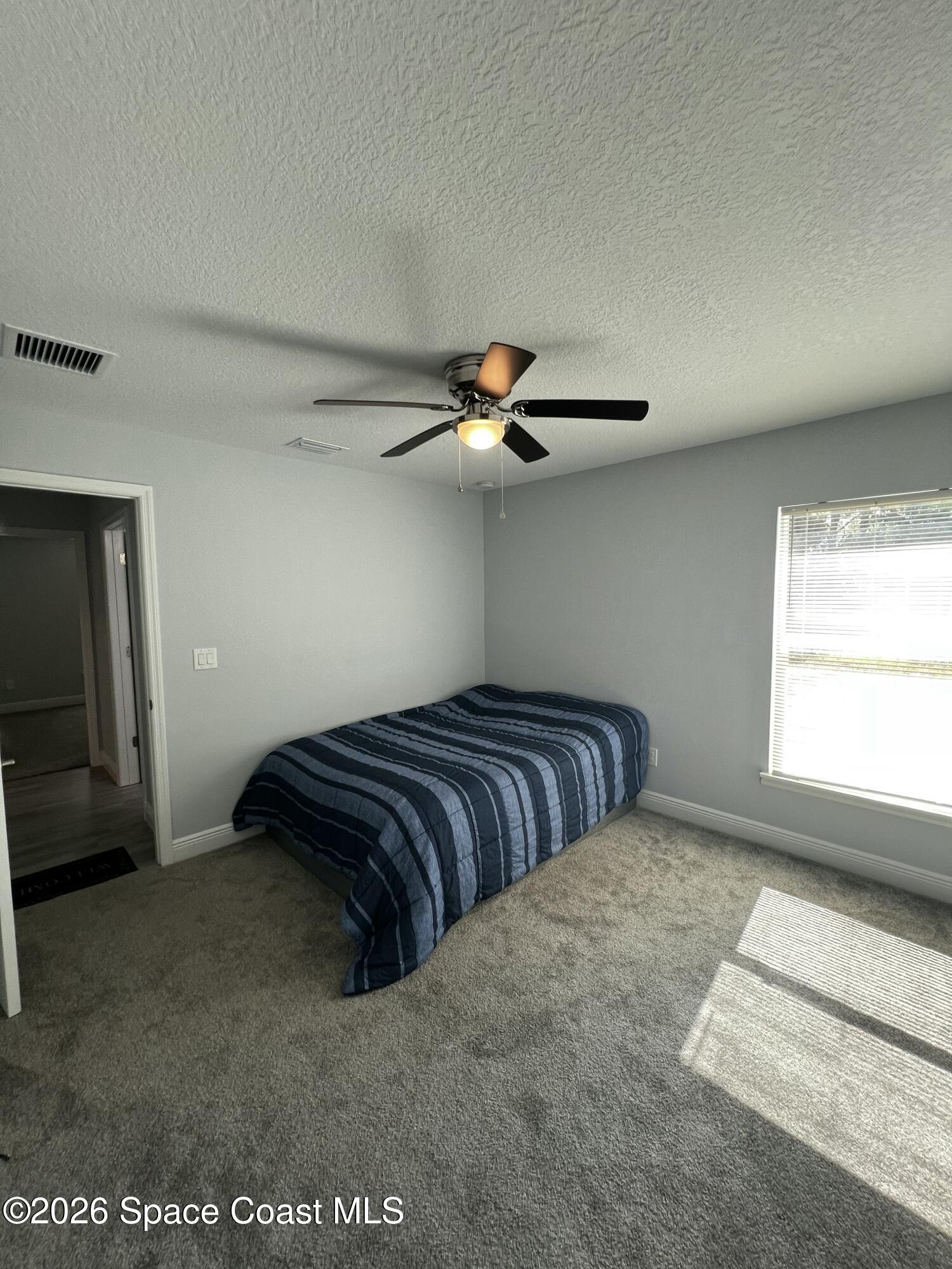 379 Wilton Avenue Southwest Melbourne, FL 32908 - Photo 20 of 26 a bedroom with bed and window