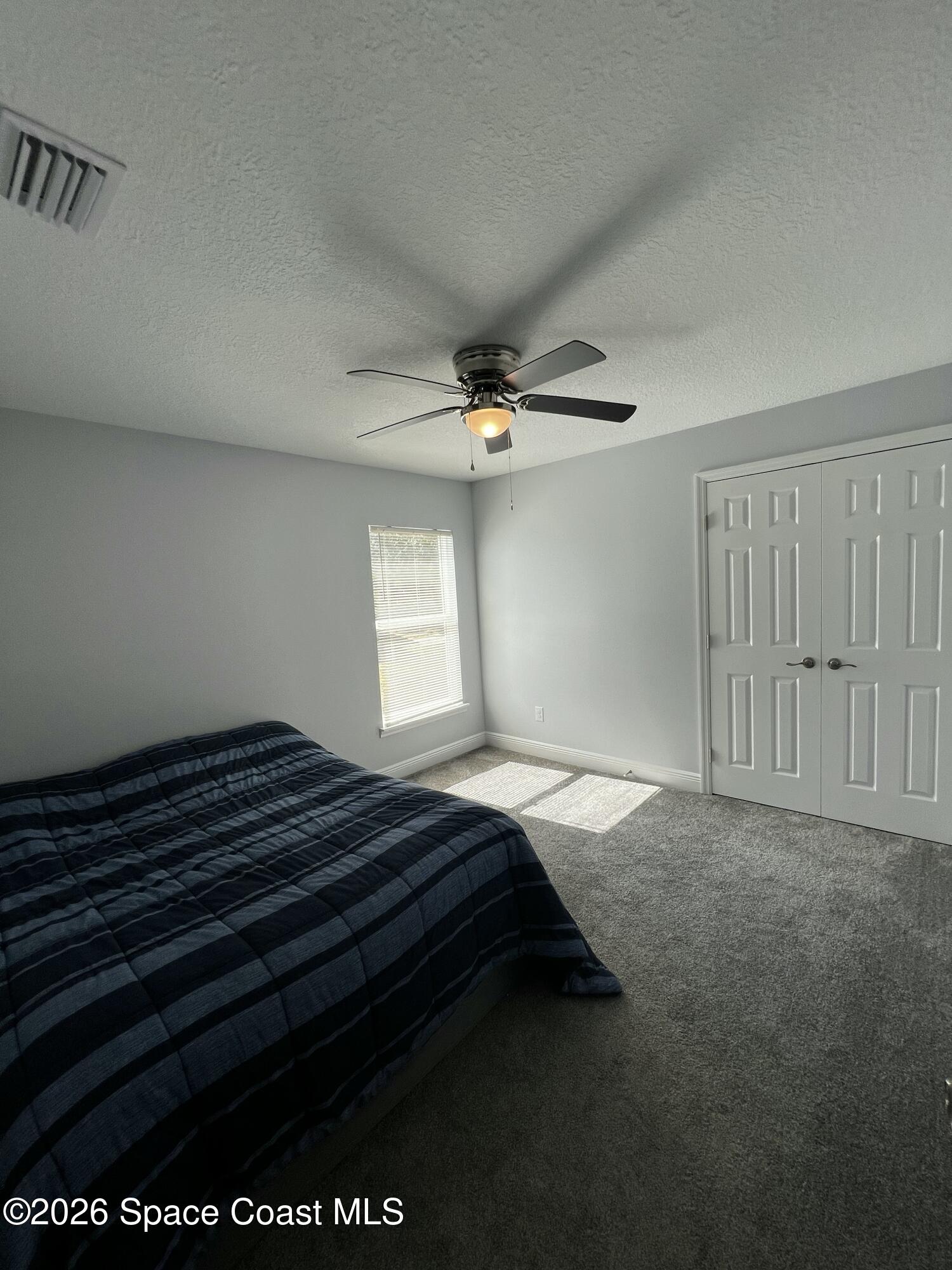 379 Wilton Avenue Southwest Melbourne, FL 32908 - Photo 21 of 26 a bedroom with a bed and a window