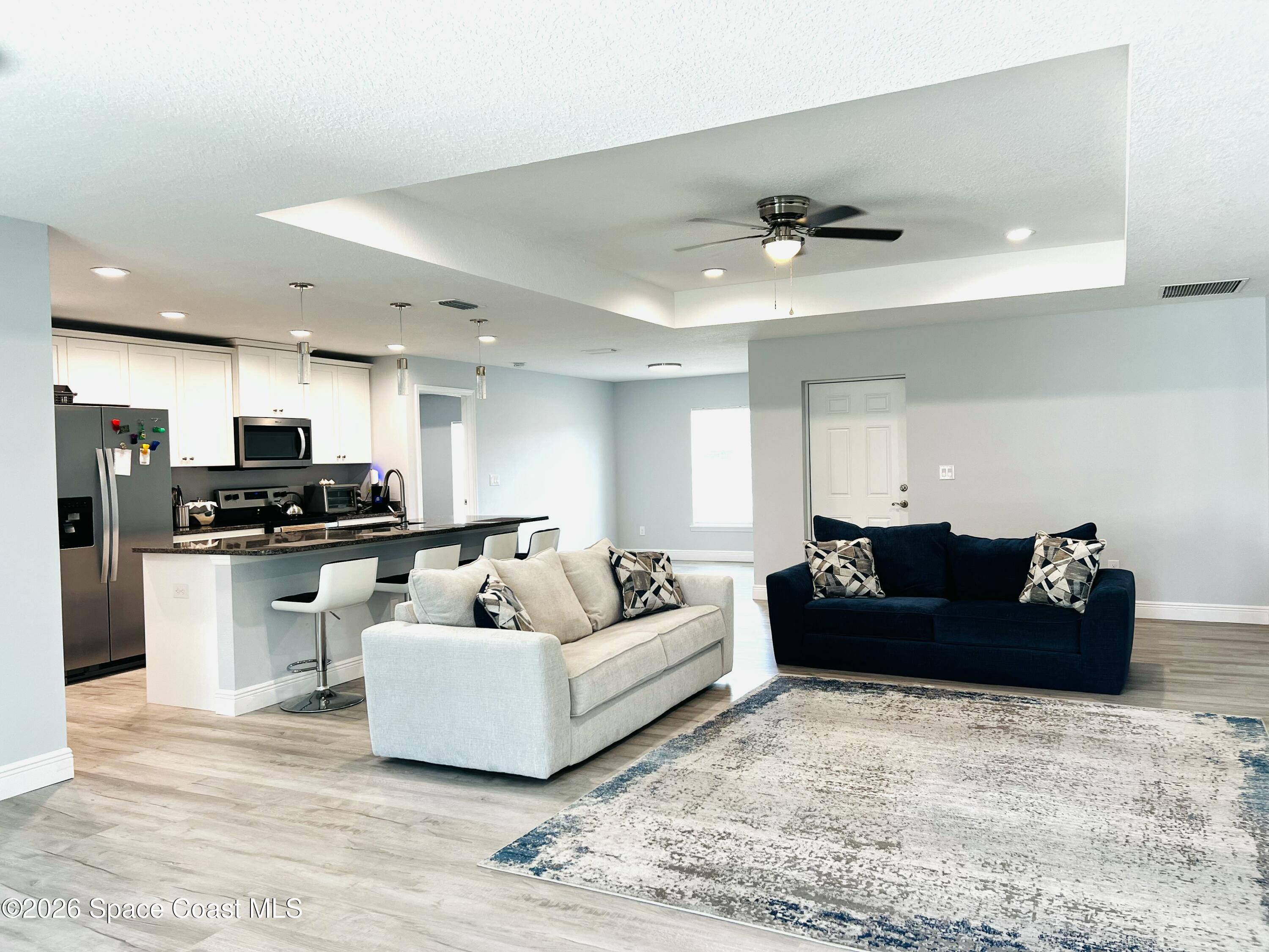 379 Wilton Avenue Southwest Melbourne, FL 32908 - Photo 4 of 26 a living room with furniture and kitchen