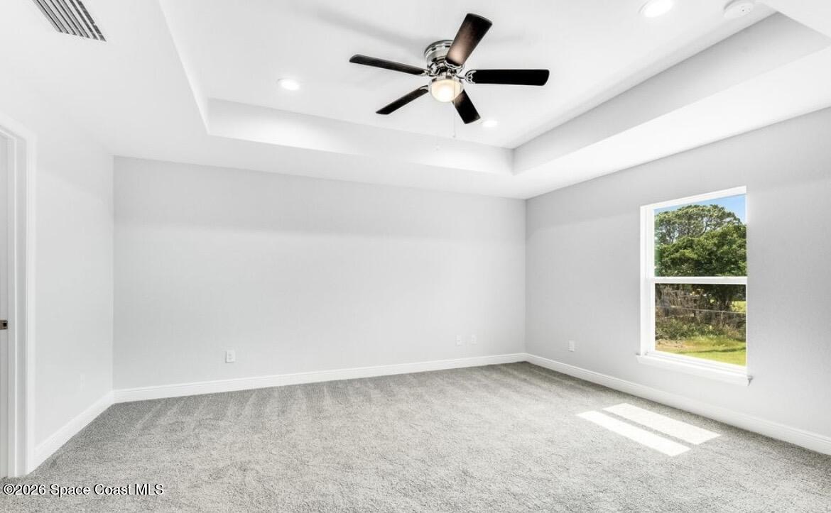 379 Wilton Avenue Southwest Melbourne, FL 32908 - Photo 10 of 26 wooden floor in an empty room with a window