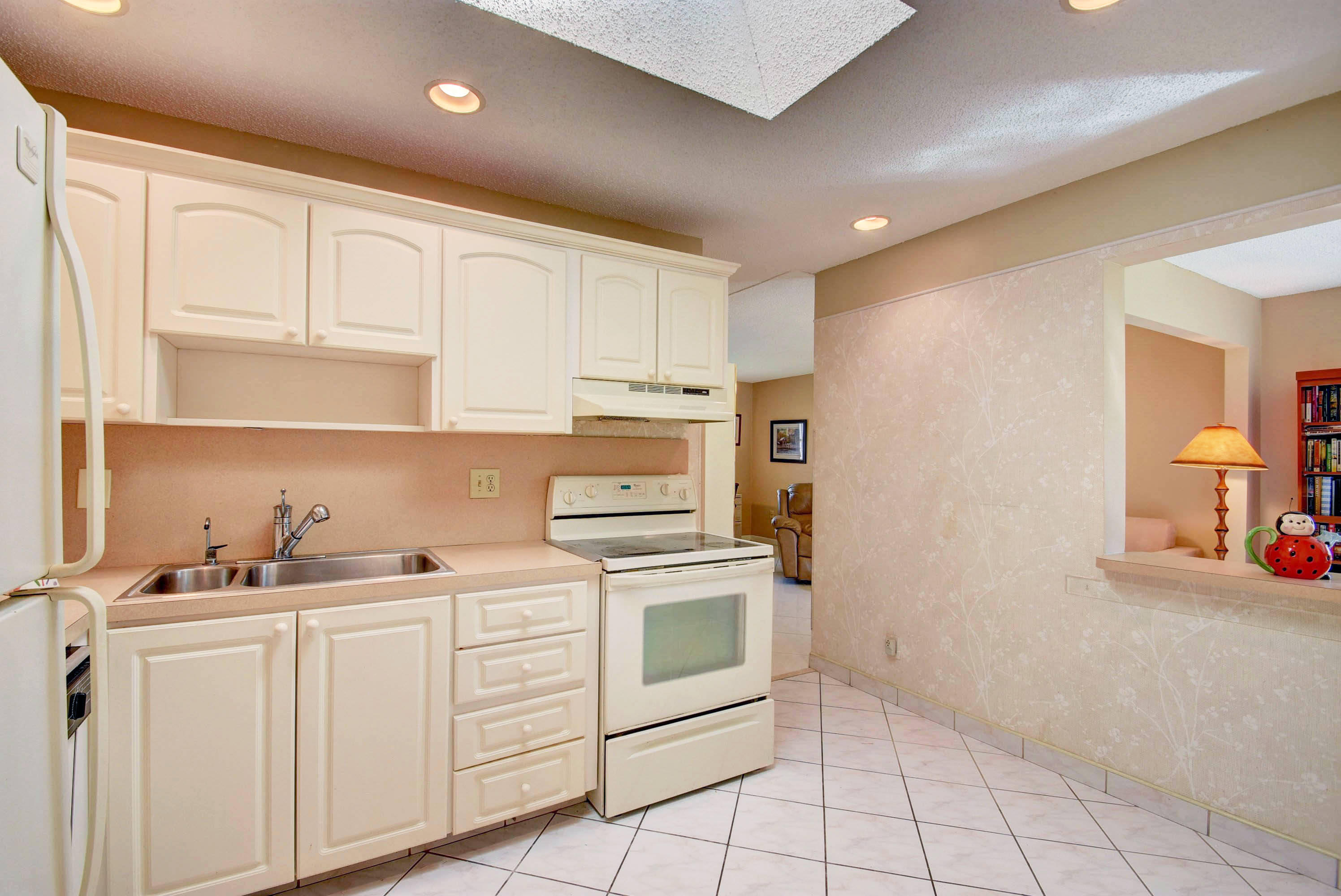 6295 Dusenburg Road Delray Beach, FL 33484 - Photo 20 of 34 a kitchen with white cabinets and white appliances
