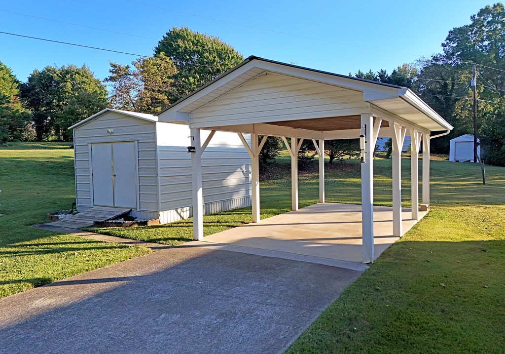 201 Coffey Road Chatsworth, GA 30705 - Photo 18 of 46 a view of a house with backyard and sitting area