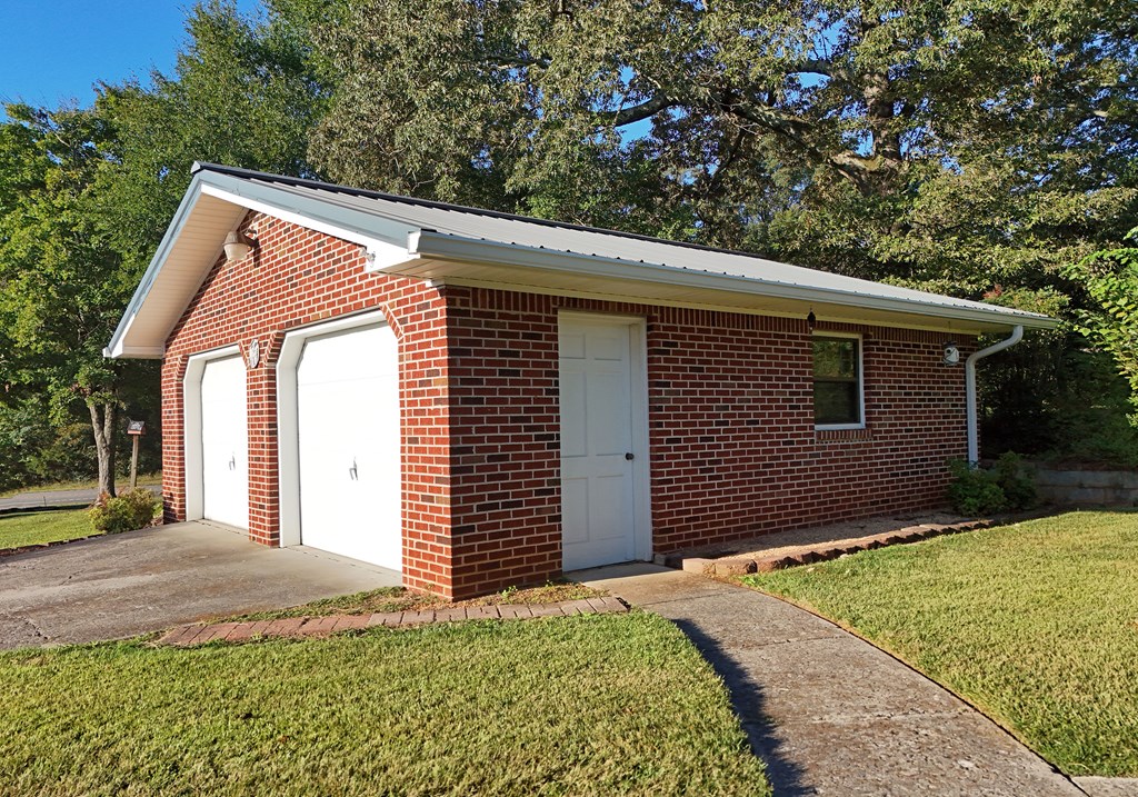 201 Coffey Road Chatsworth, GA 30705 - Photo 22 of 46 a front view of a house with a garden