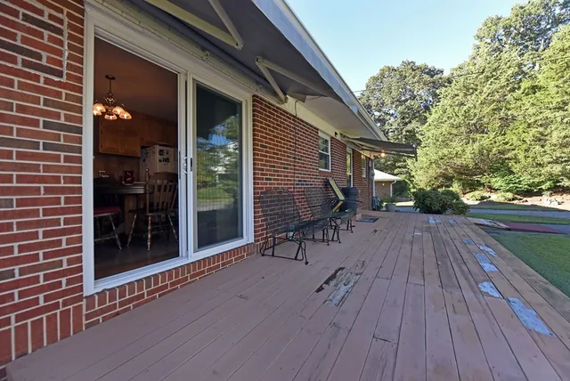 a view of a house with backyard and sitting area