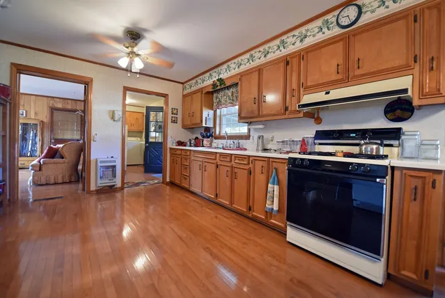a kitchen with stainless steel appliances granite countertop a stove and cabinets