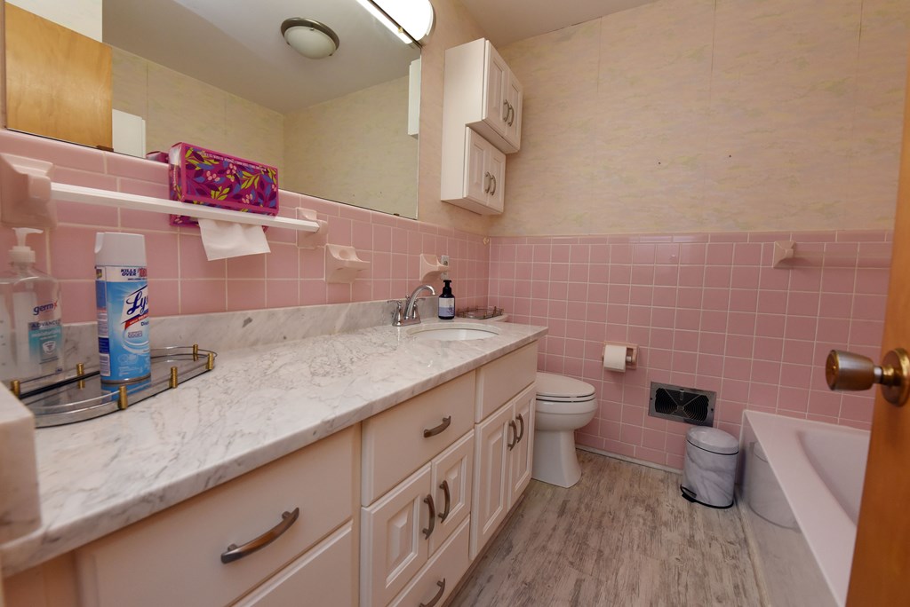 201 Coffey Road Chatsworth, GA 30705 - Photo 46 of 46 a bathroom with a granite countertop toilet sink and mirror