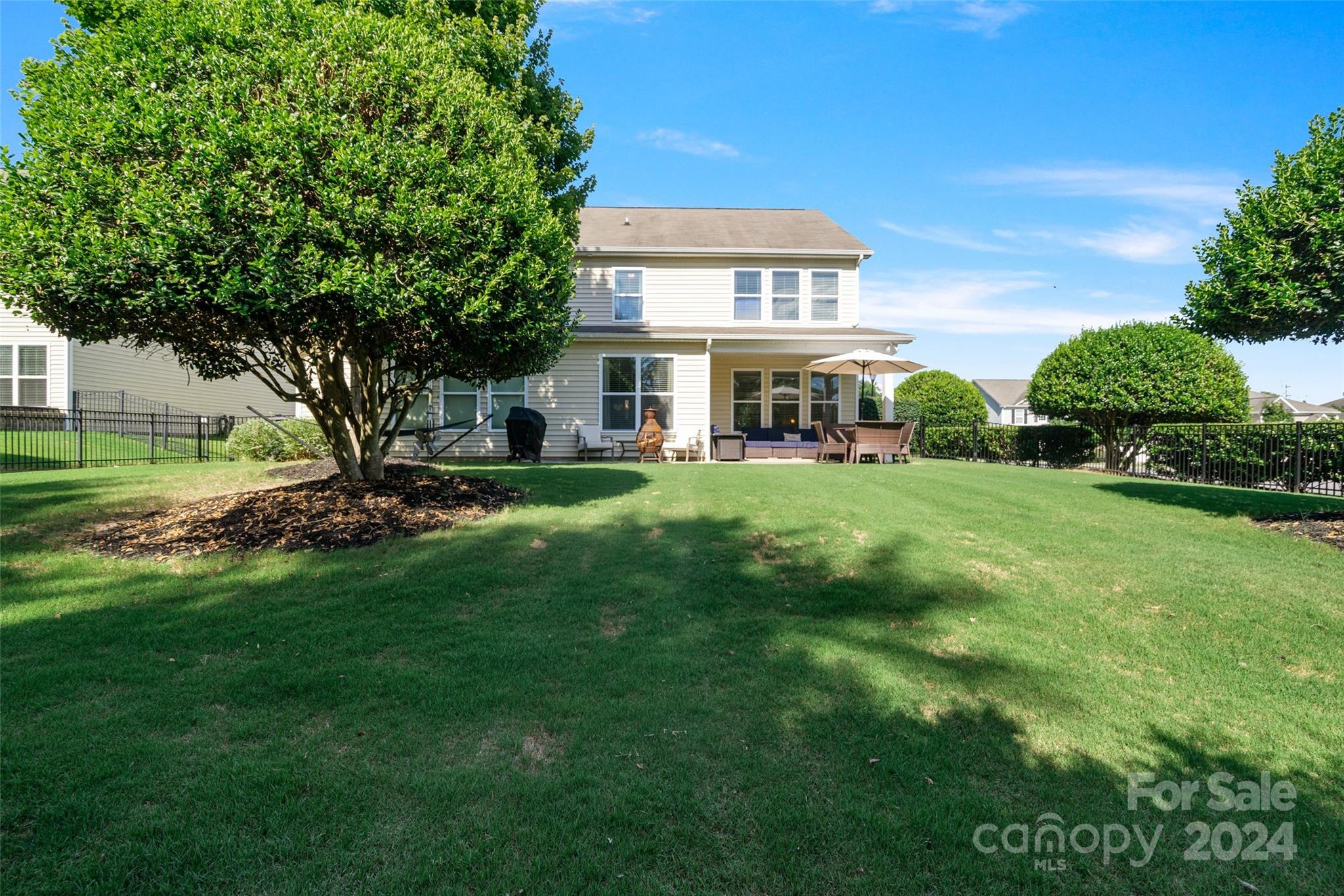 105 Annatto Way Fort Mill, SC 29708 - Photo 20 of 32 a view of a house with a big yard and large trees
