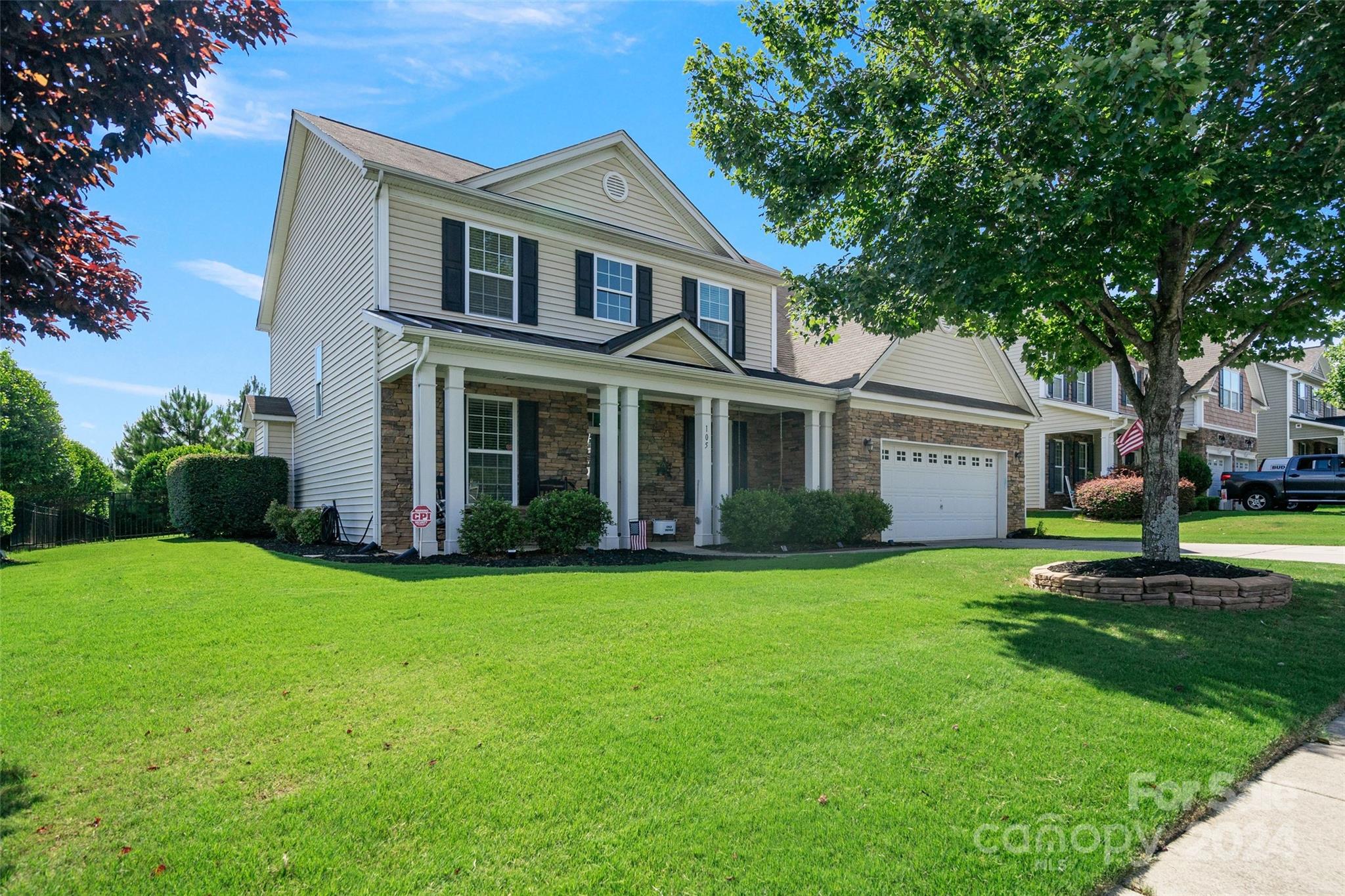 105 Annatto Way Fort Mill, SC 29708 - Photo 2 of 32 a front view of a house with a garden and trees