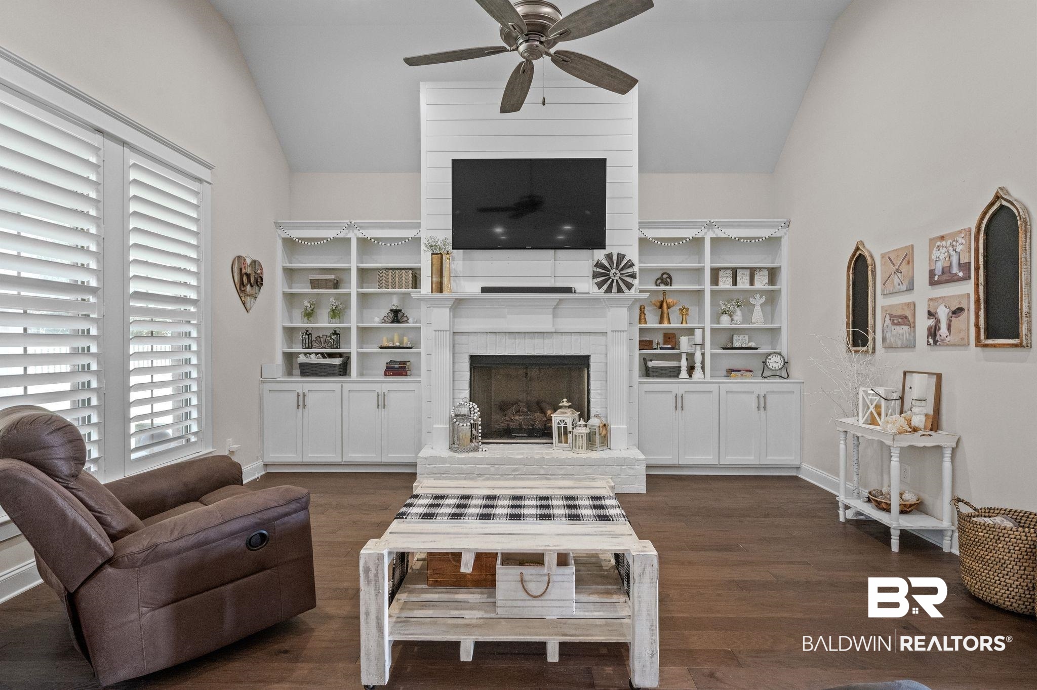 32194 Badger Court Daphne, AL 36527 - Photo 10 of 49 Living area featuring lofted ceiling, a fireplace, dark wood-style flooring, built in shelves, and ceiling fan