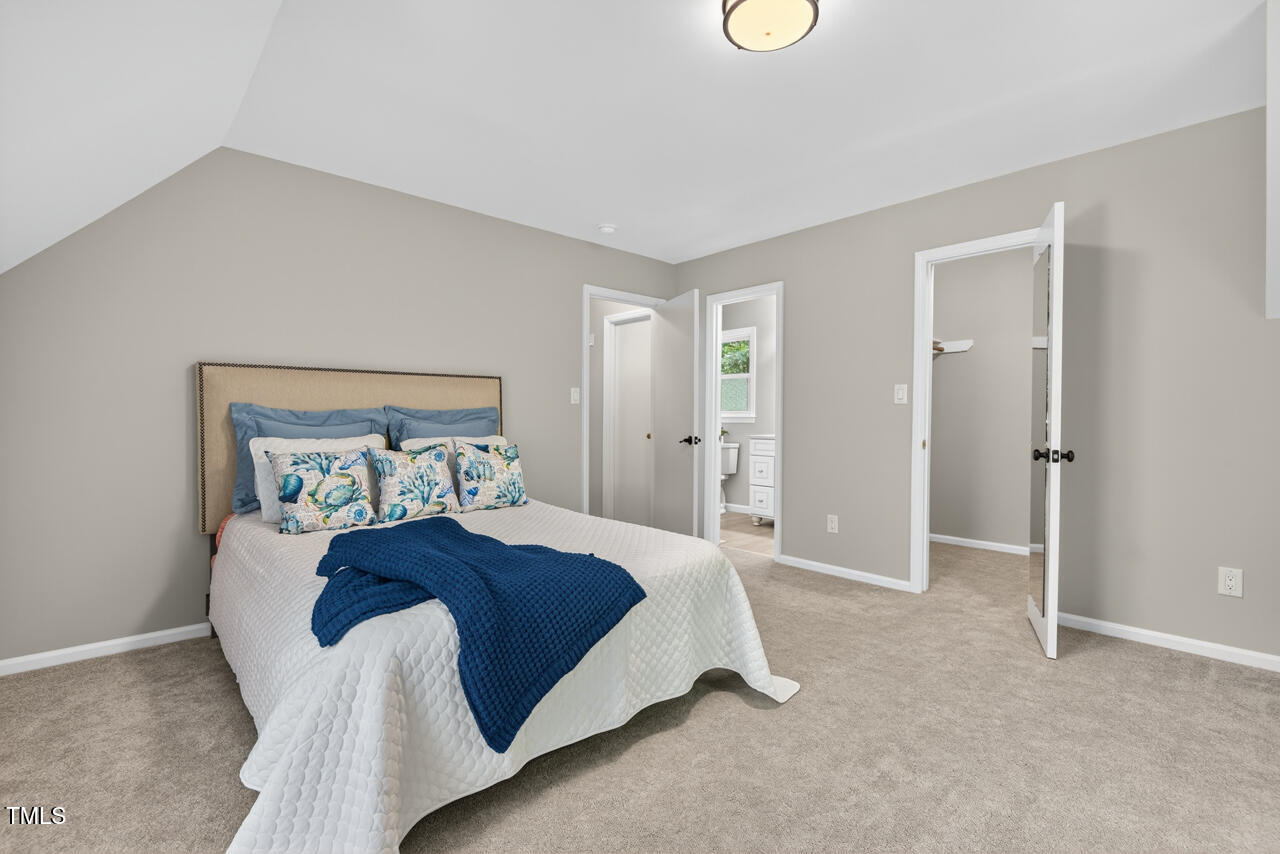 1500 Valley Run Durham, NC 27707 - Photo 20 of 29 a bedroom with a bed and a lamp