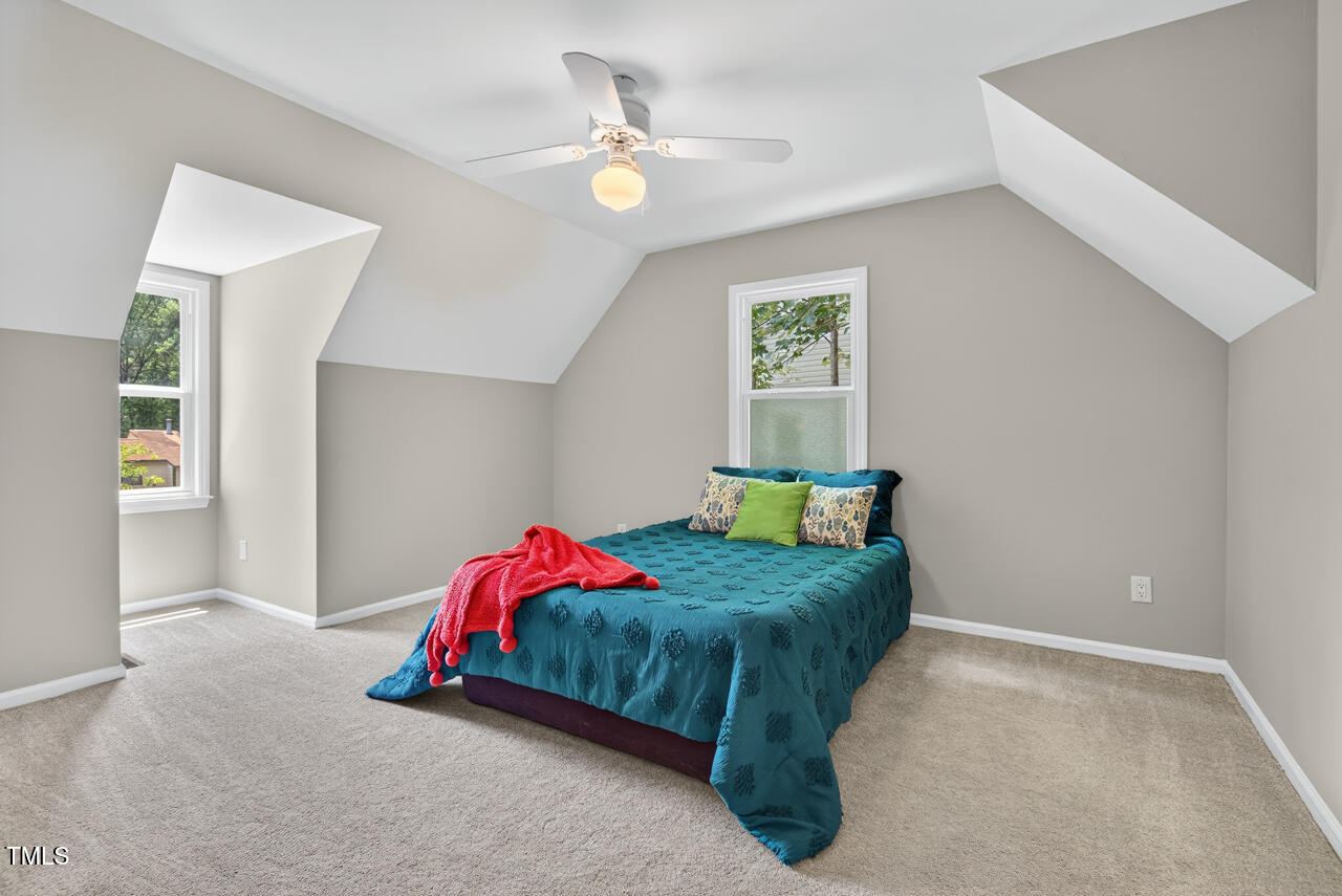 1500 Valley Run Durham, NC 27707 - Photo 24 of 29 a bedroom with a bed and a chandelier