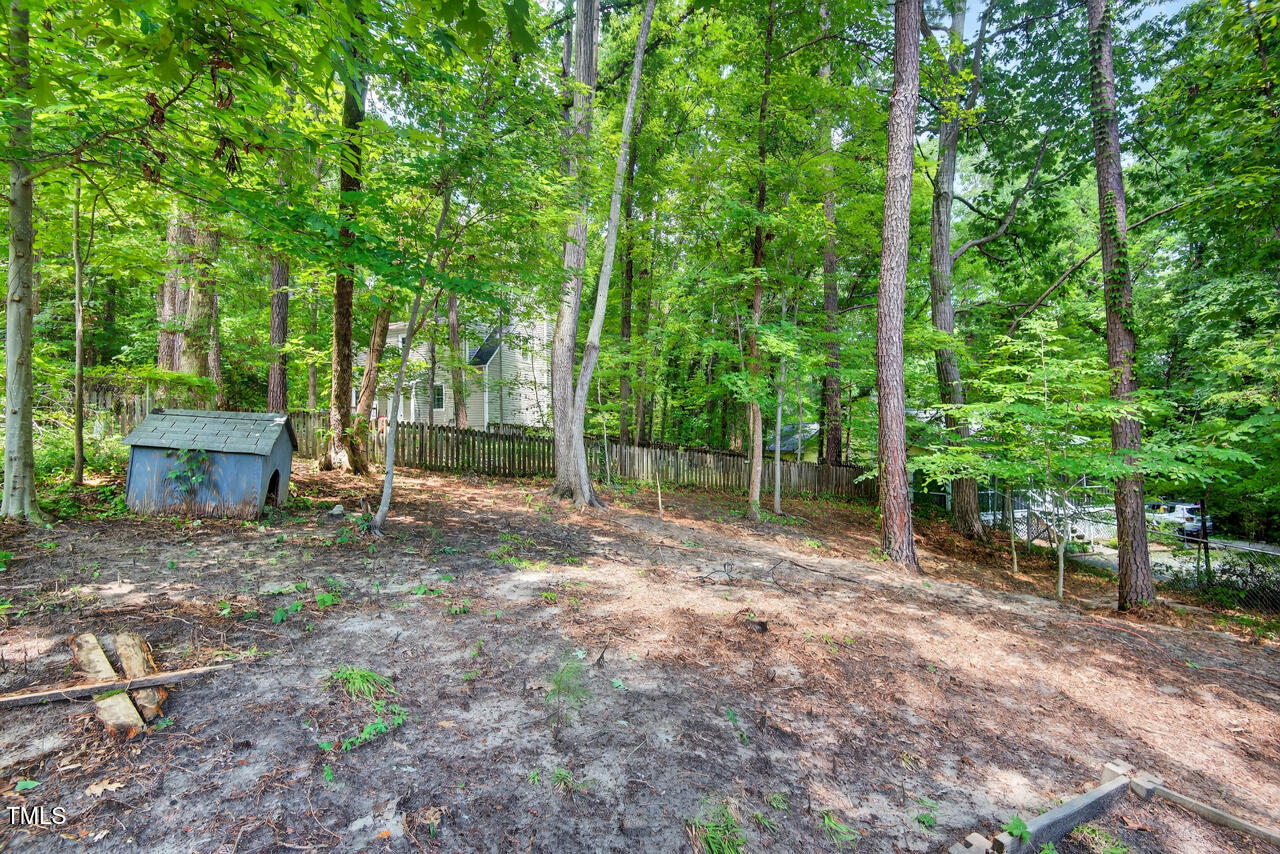 1500 Valley Run Durham, NC 27707 - Photo 29 of 29 a view of a backyard with large trees and wooden fence