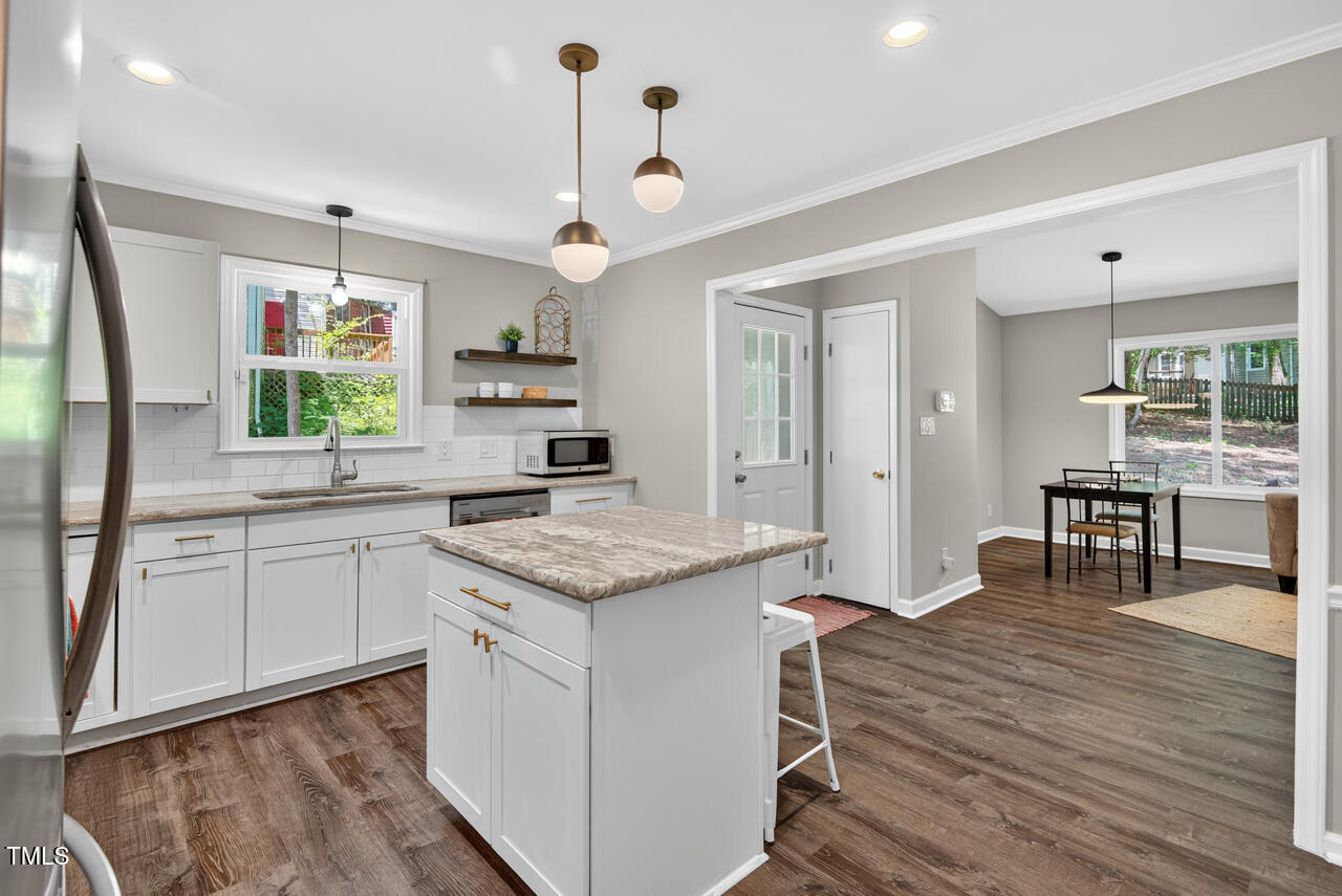 1500 Valley Run Durham, NC 27707 - Photo 7 of 29 a kitchen with granite countertop white cabinets and black appliances