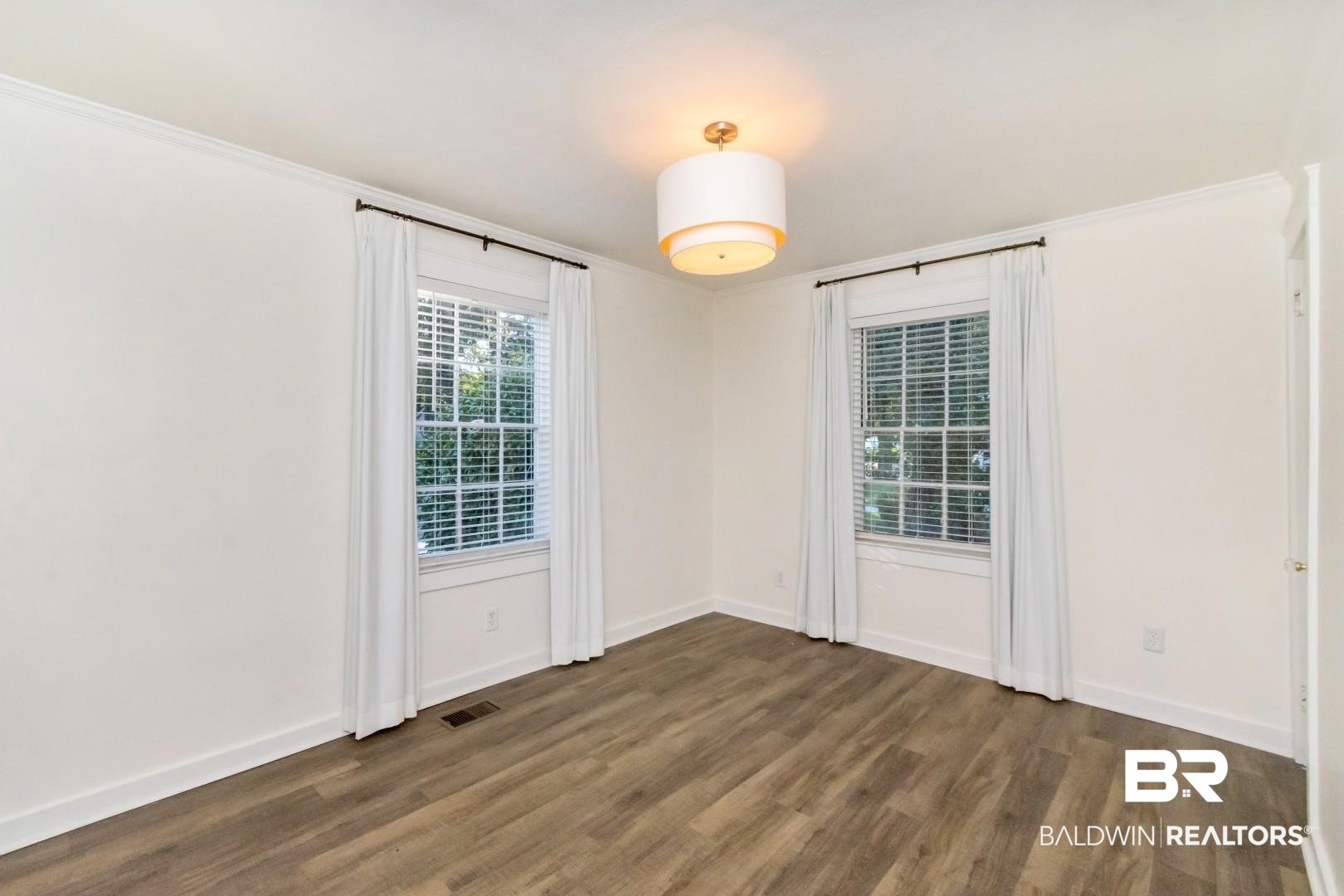 16 Princess Anne Road Mobile, AL 36608 - Photo 23 of 40 Empty room featuring dark wood-type flooring and ornamental molding