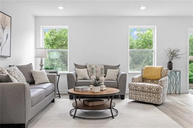 a living room with furniture and a large window