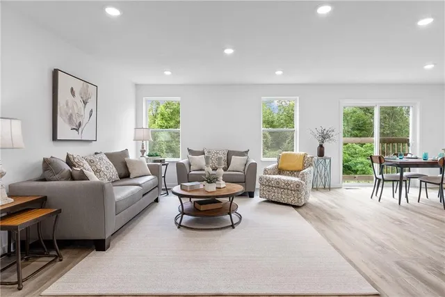 a living room with furniture and a large window