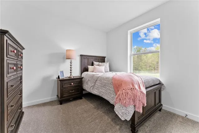 a bed sitting in a bedroom next to a window