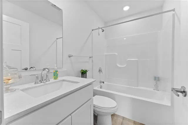 a bathroom with a sink mirror toilet and bathtub