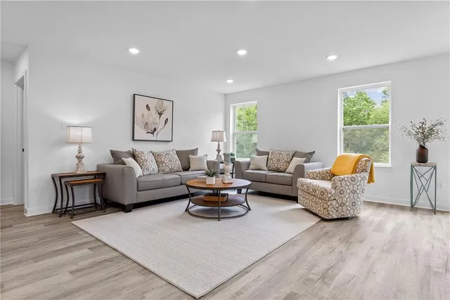 a living room with furniture and a large window