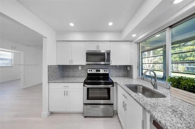 a kitchen that has a sink and a stove