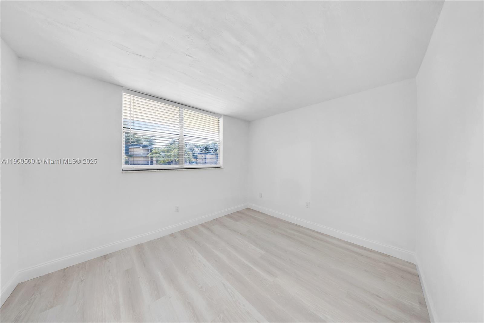 9090 Lime Bay Boulevard, Unit 211 Tamarac, FL 33321 - Photo 13 of 23 an empty room with a window