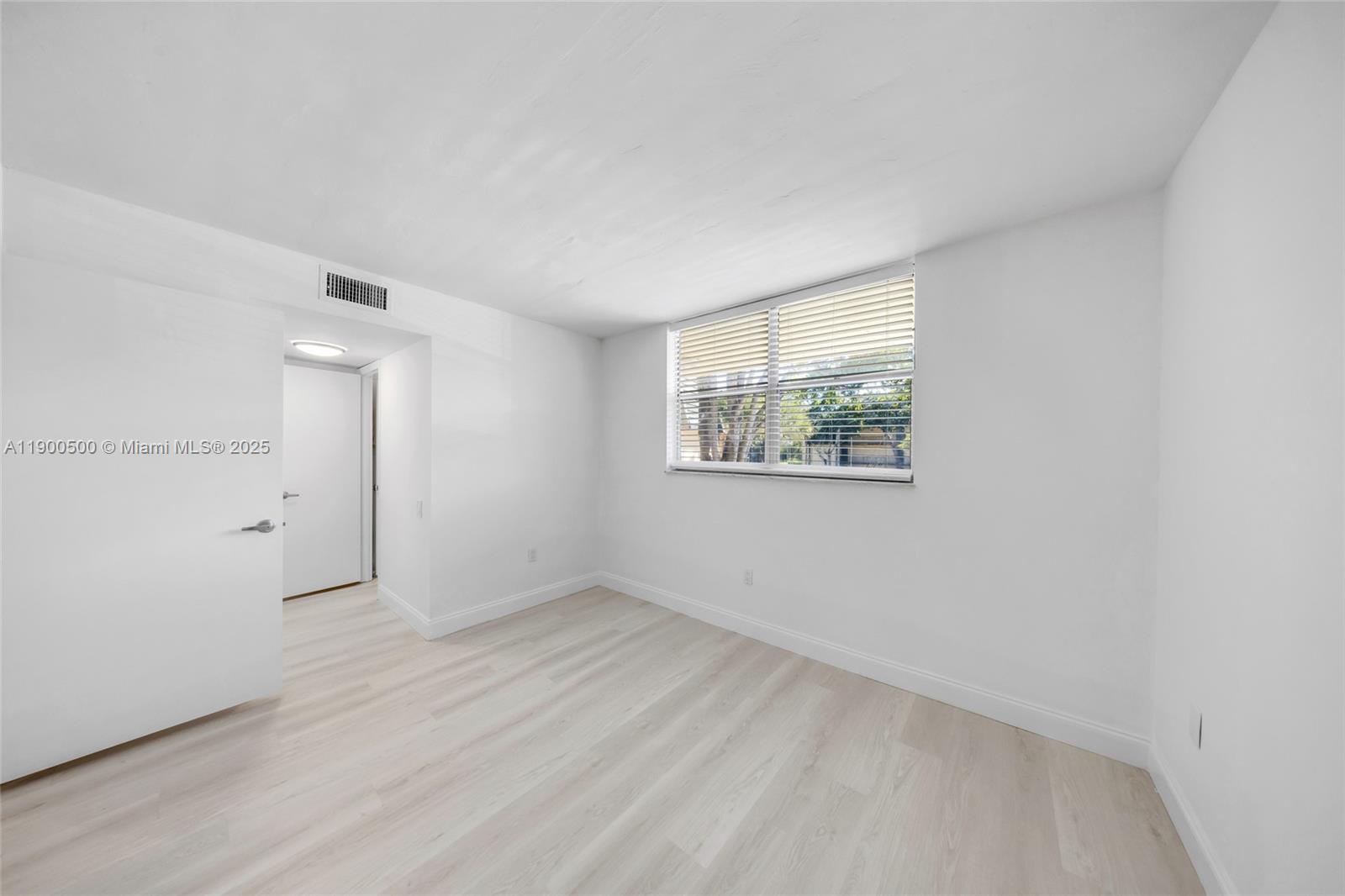 9090 Lime Bay Boulevard, Unit 211 Tamarac, FL 33321 - Photo 15 of 23 a view of an empty room with a window