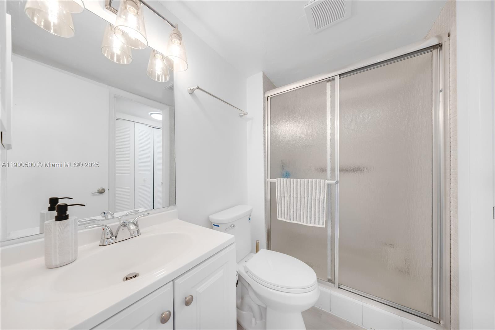 9090 Lime Bay Boulevard, Unit 211 Tamarac, FL 33321 - Photo 16 of 23 a bathroom with a sink toilet and shower