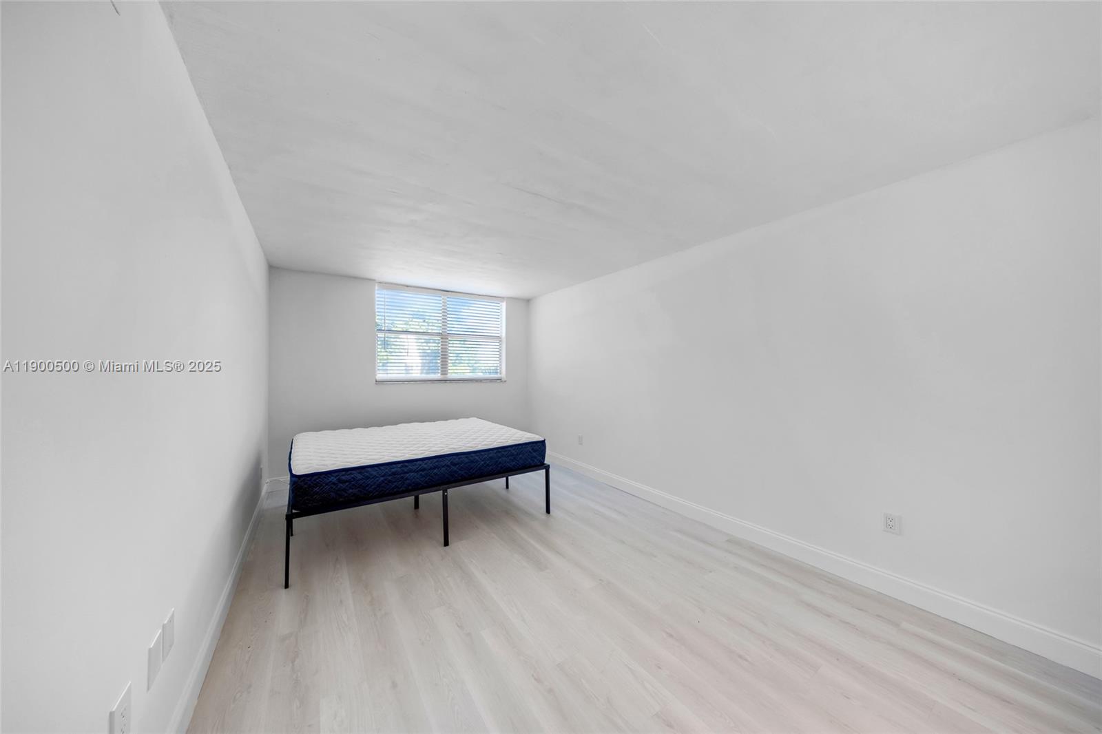 9090 Lime Bay Boulevard, Unit 211 Tamarac, FL 33321 - Photo 17 of 23 a room with a bed and a window