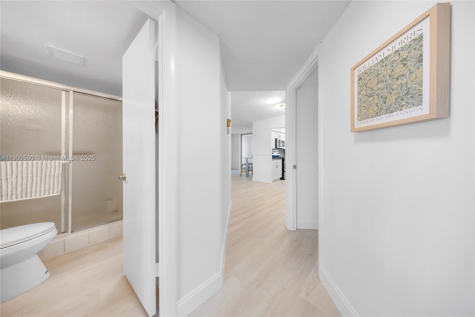 9090 Lime Bay Boulevard, Unit 211 Tamarac, FL 33321 - Photo 5 of 23 a view of a bathroom from a hallway
