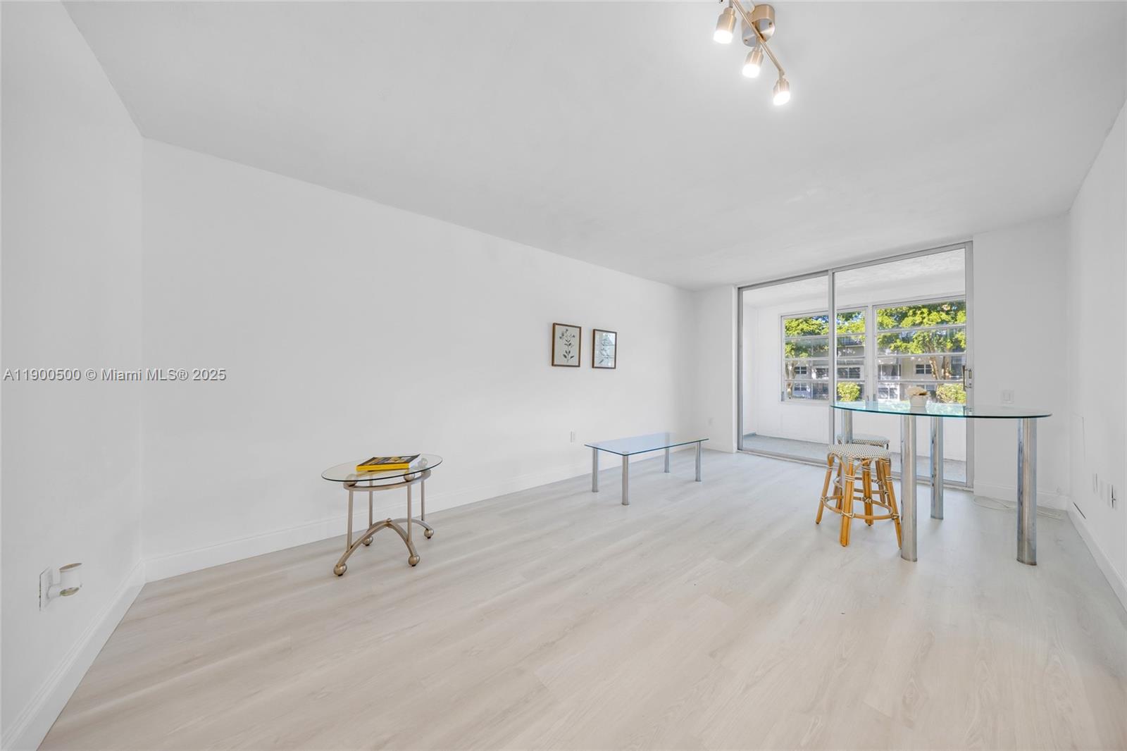 9090 Lime Bay Boulevard, Unit 211 Tamarac, FL 33321 - Photo 6 of 23 a view of dining room with furniture and a wooden floor