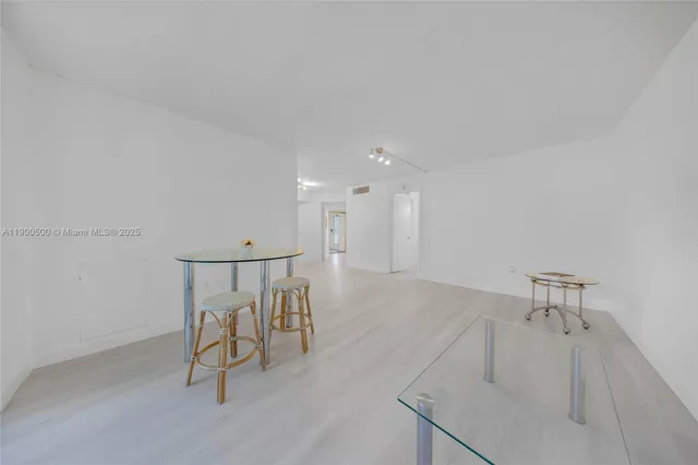 a view of a room with a table and chairs