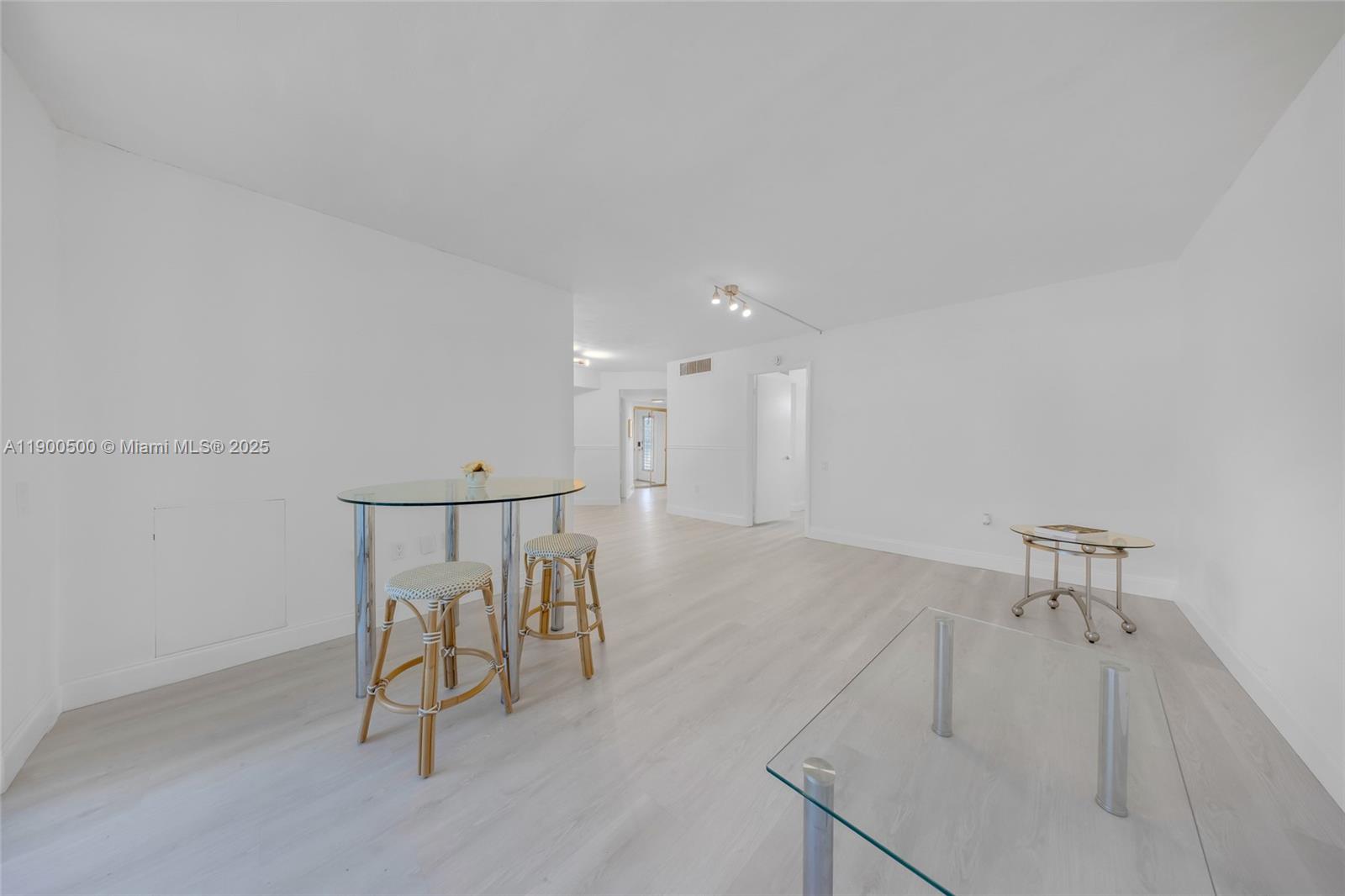 9090 Lime Bay Boulevard, Unit 211 Tamarac, FL 33321 - Photo 8 of 23 a view of a room with a table and chairs