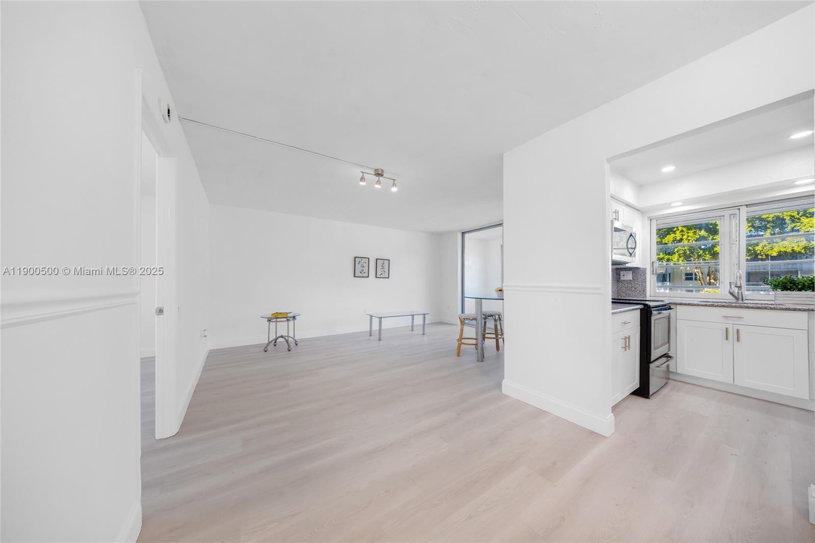 9090 Lime Bay Boulevard, Unit 211 Tamarac, FL 33321 - Photo 9 of 23 a room with furniture and window