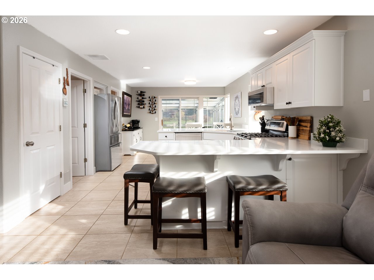 38 Denmark Loop Silverton, OR 97381 - Photo 11 of 47 a kitchen with stainless steel appliances granite countertop a table chairs sink and cabinets