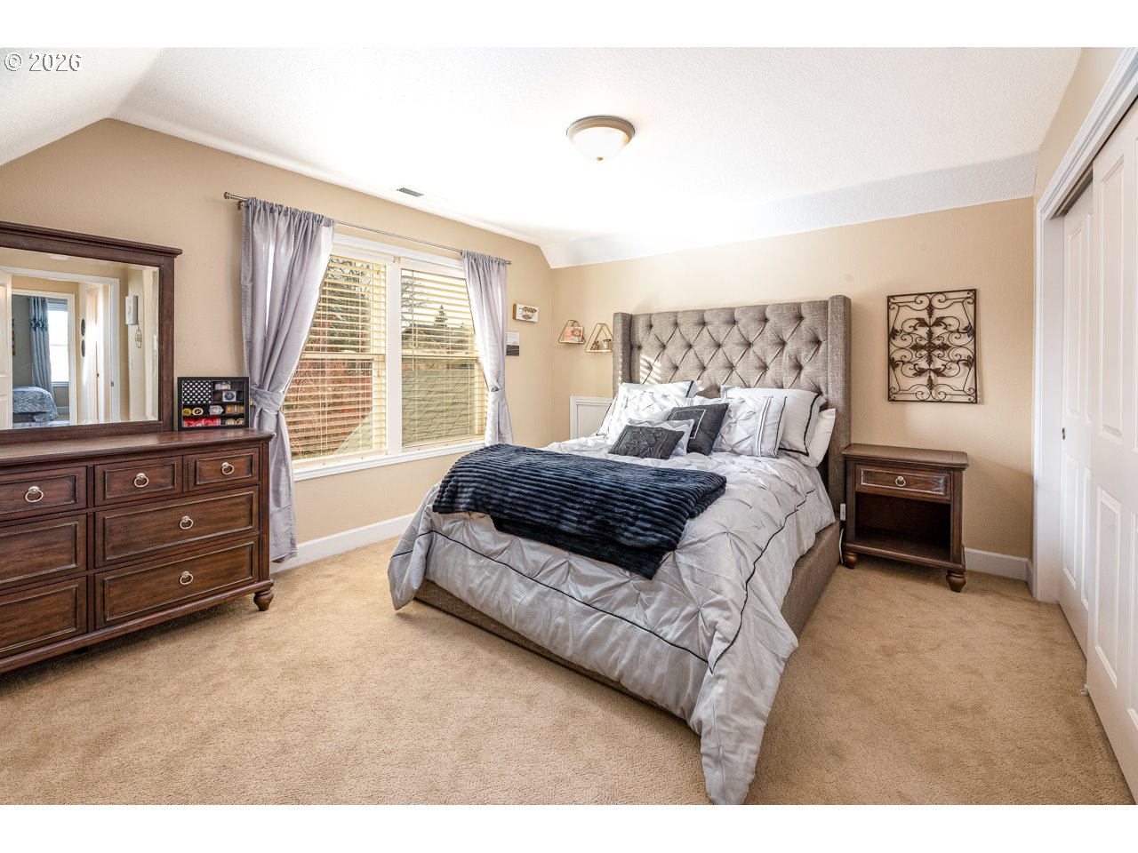 38 Denmark Loop Silverton, OR 97381 - Photo 29 of 47 a spacious bedroom with a bed a dresser and a window