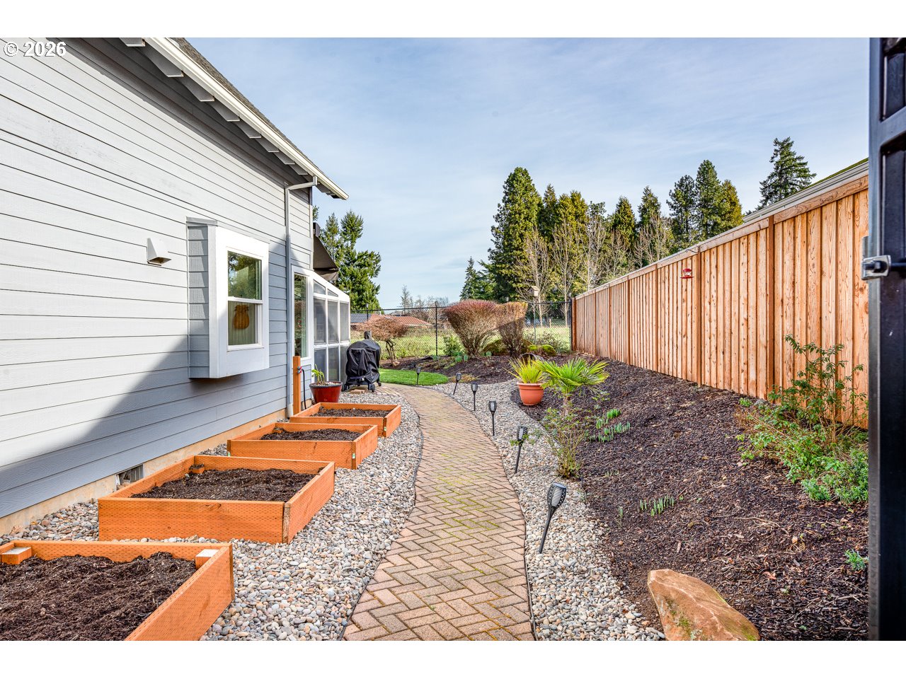 38 Denmark Loop Silverton, OR 97381 - Photo 37 of 47 a backyard of a house with table and chairs