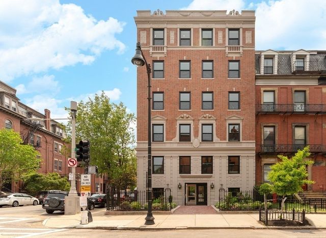 a front view of a residential apartment building with a yard