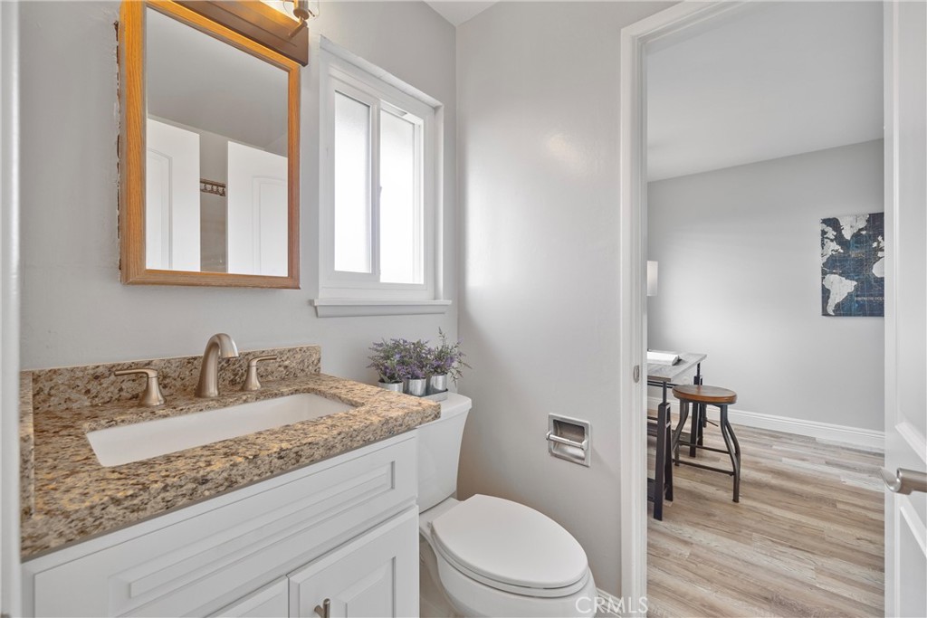 2810 East Echo Hill Way Orange, CA 92867 - Photo 22 of 49 a bathroom with a granite countertop sink a toilet and a mirror