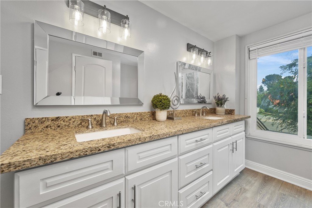 2810 East Echo Hill Way Orange, CA 92867 - Photo 34 of 49 a bathroom with double sink and a mirror