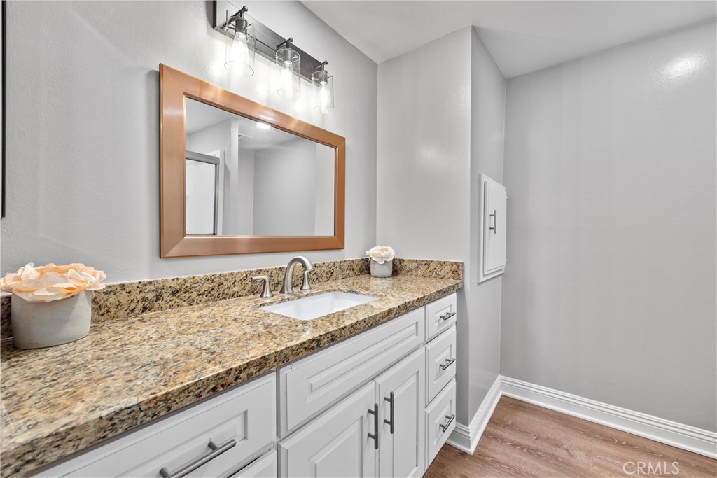2810 East Echo Hill Way Orange, CA 92867 - Photo 36 of 49 a bathroom with a granite countertop sink and a mirror