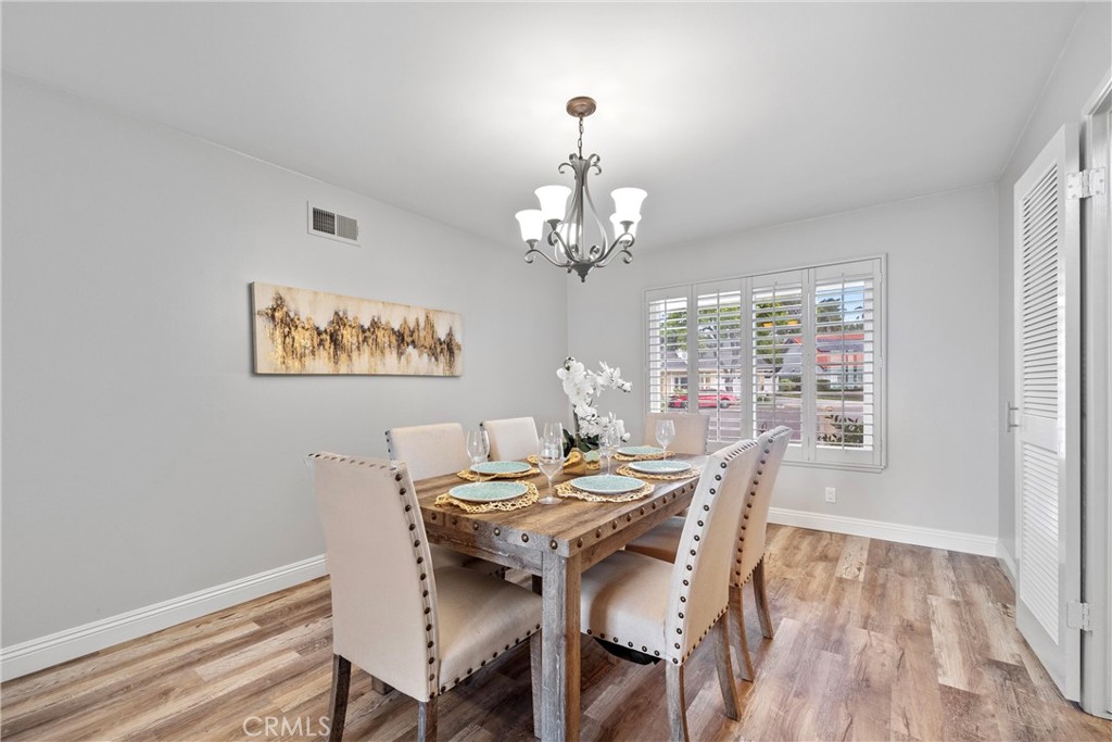 2810 East Echo Hill Way Orange, CA 92867 - Photo 8 of 49 a view of a dining room with furniture a chandelier and wooden floor