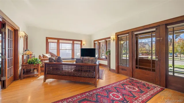 a dining room with furniture a chandelier and wooden floor