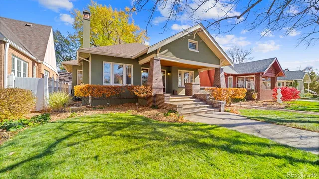 a front view of a house with a yard table and chairs