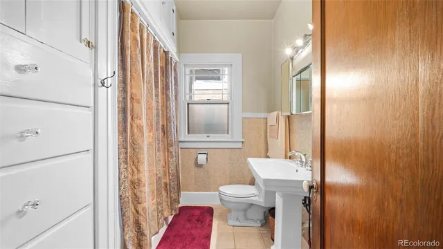 a living room with furniture and a dresser