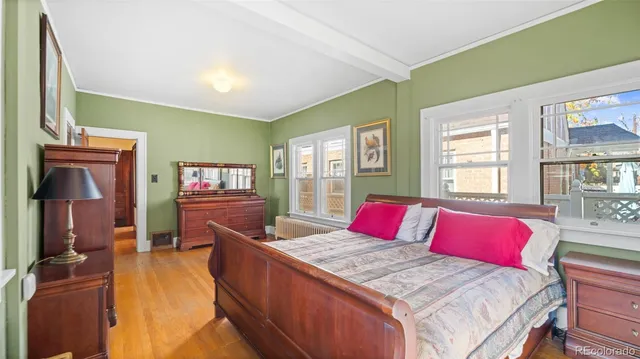 a kitchen with stainless steel appliances granite countertop a refrigerator a stove and a wooden floors