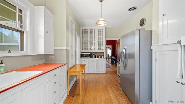 a room with cabinets a sink and appliances