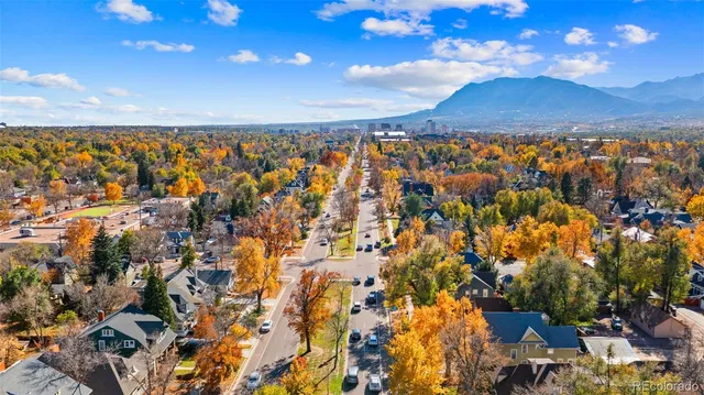 an aerial view of a house with a yard and wooden fence