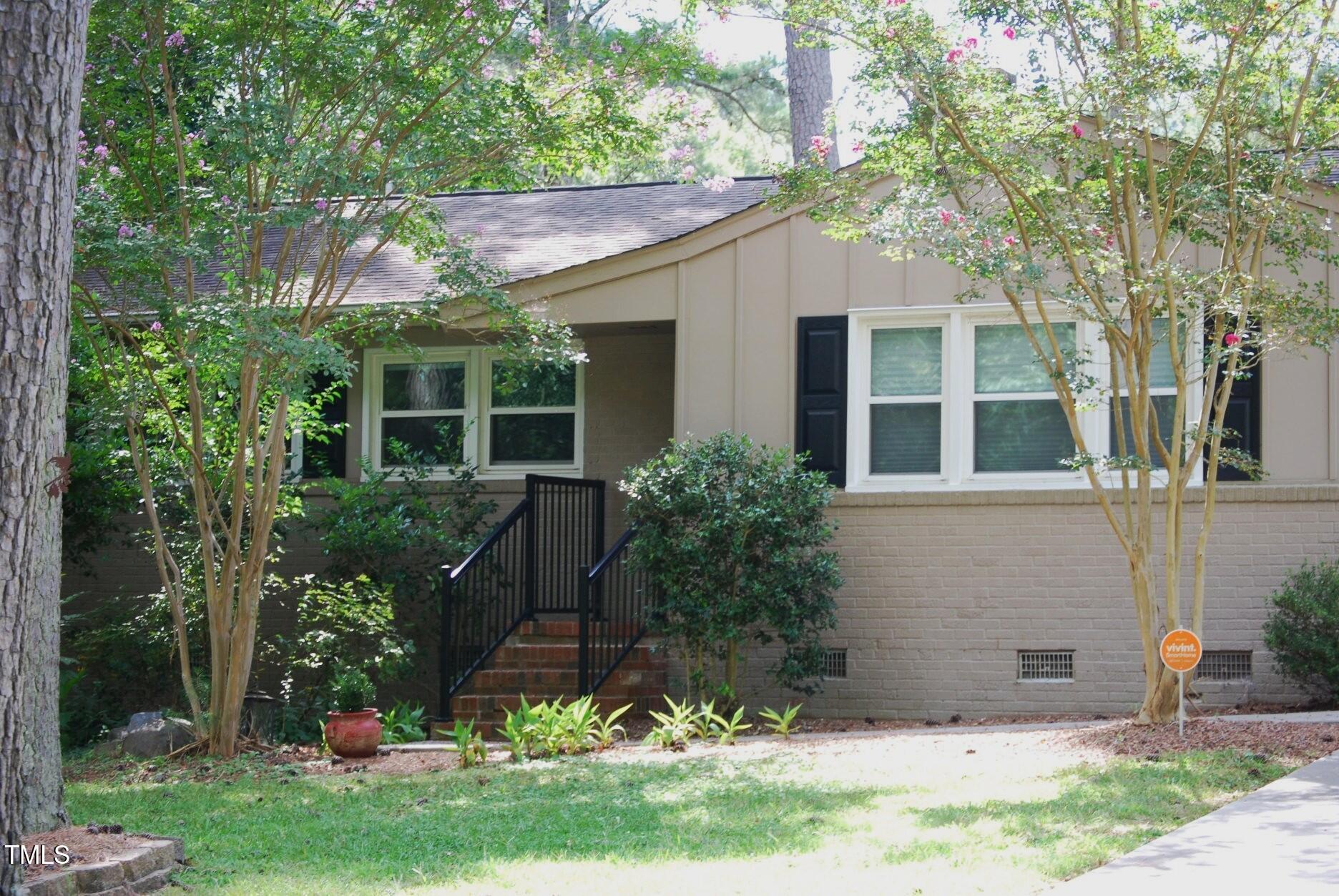 a view of house with a yard