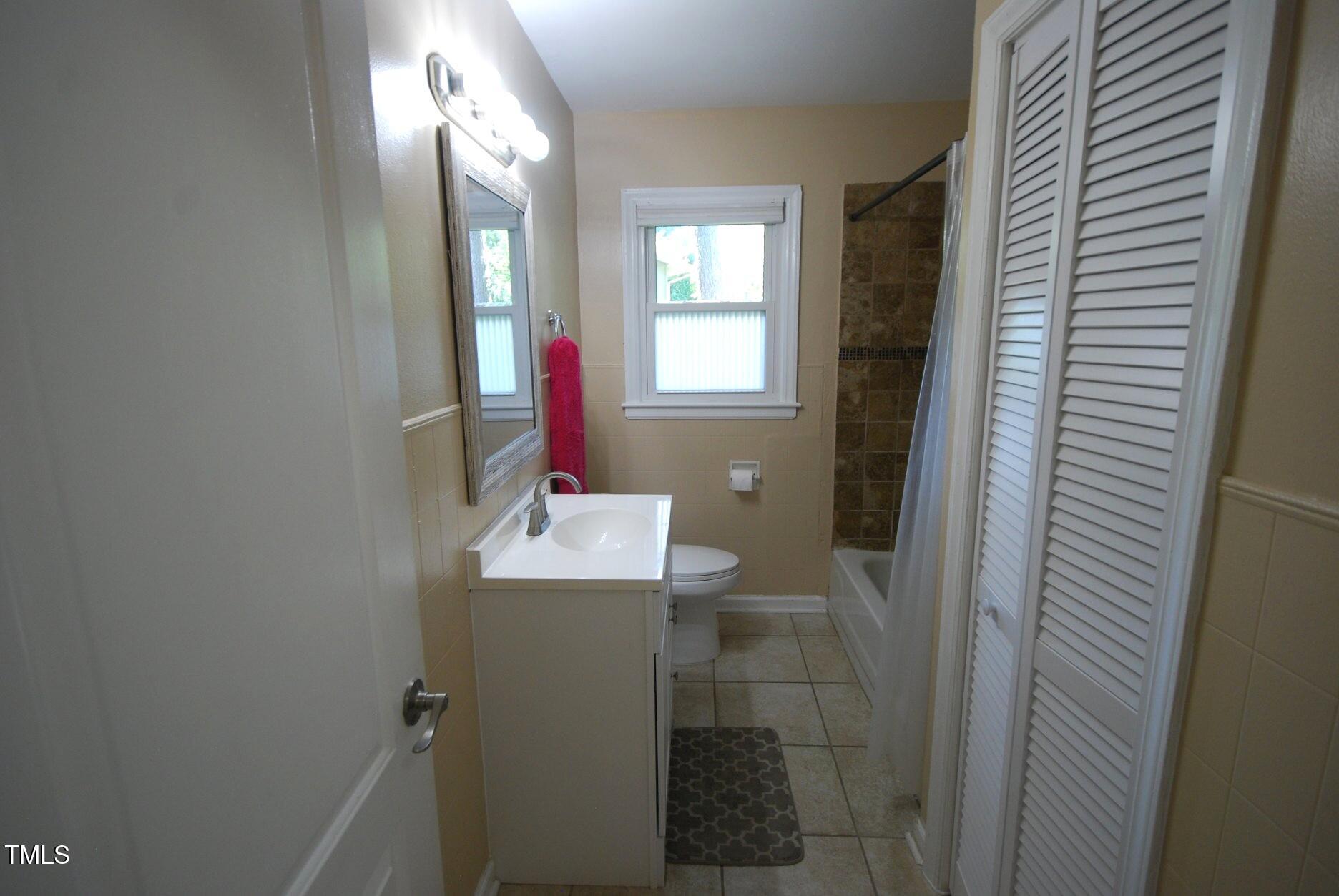 416 Morreene Road Durham, NC 27705 - Photo 12 of 28 a bathroom with a sink vanity and mirror